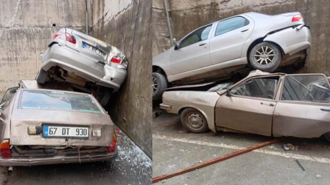 Rampadan geri kayıp 8 metrelik duvardan düştü: Park halindeki aracın üzerine çıktı